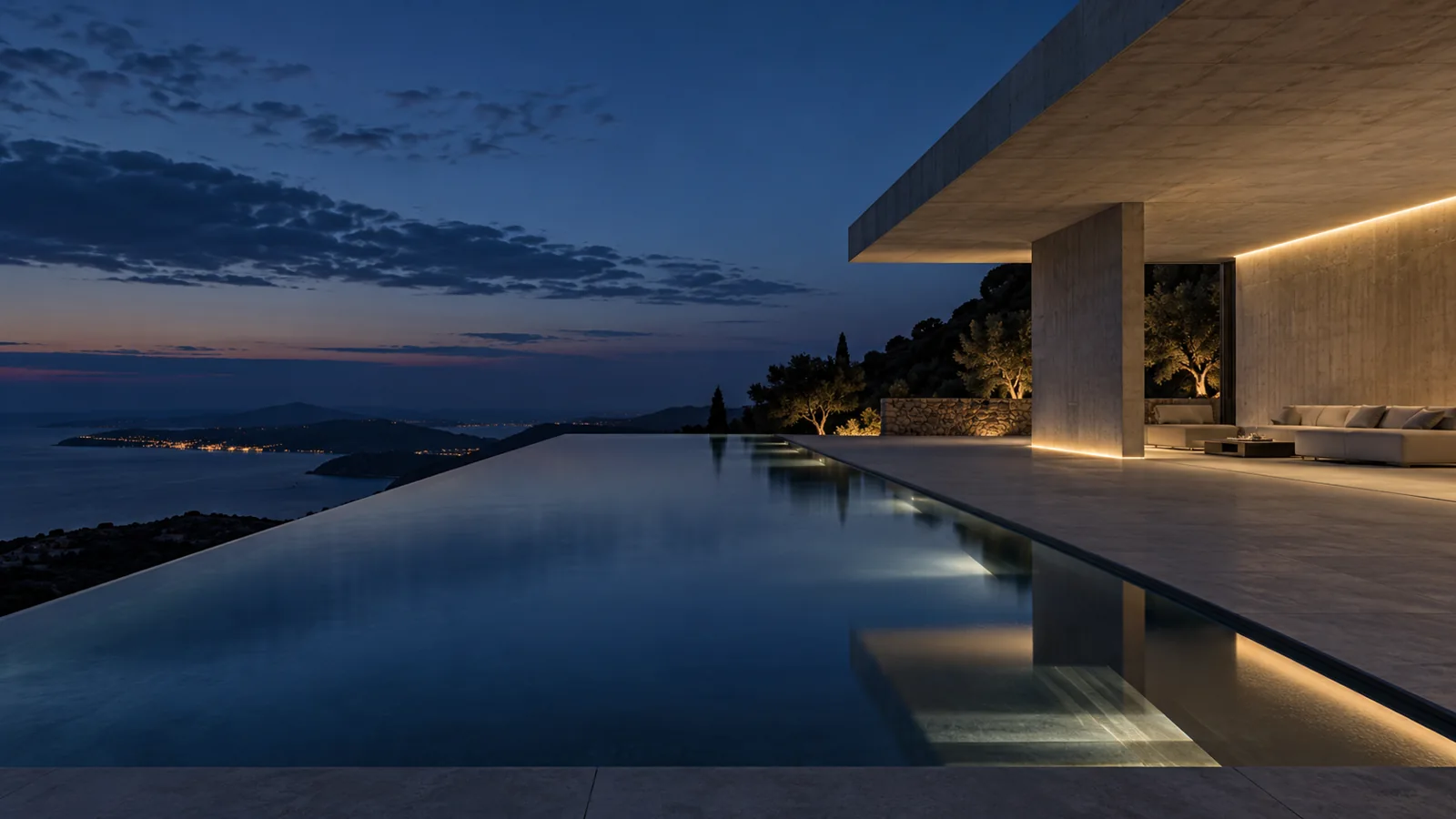 Concrete infinity pool and geometric pavilion at dusk